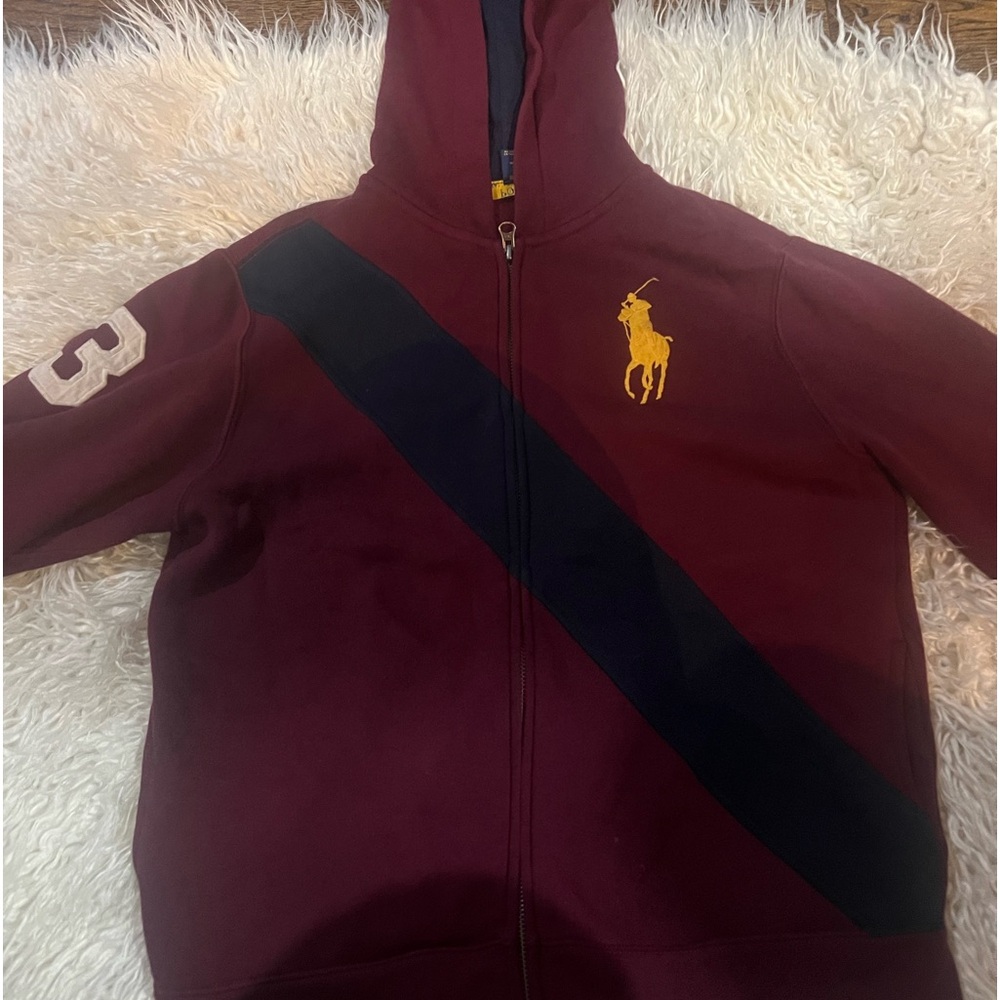Ralph Lauren Hoodie Burgundy with a blue stripe across chest .